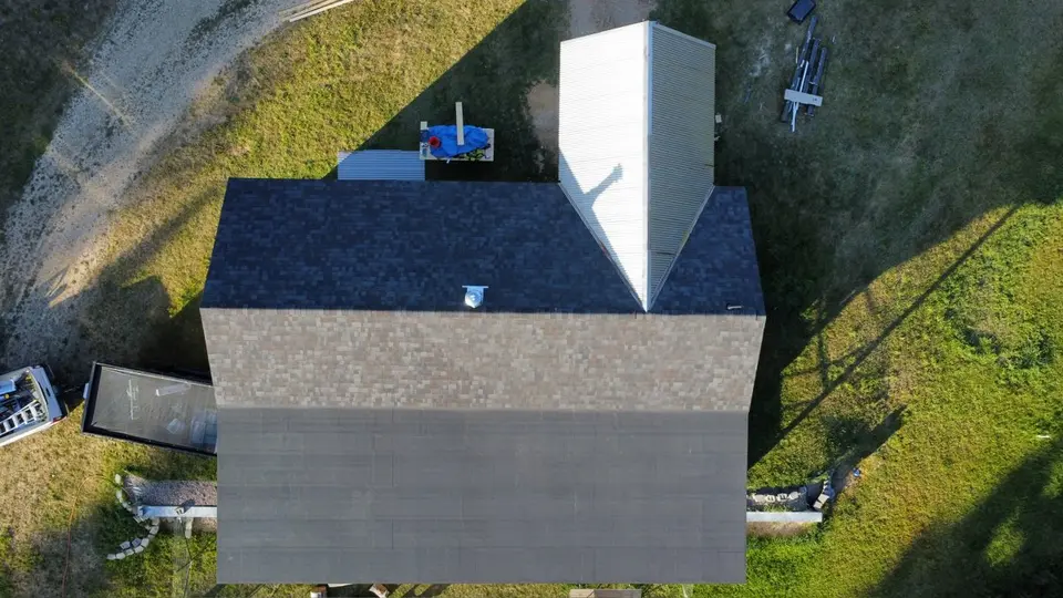 Aerial view of a home in the Flathead Valley with panel siding, surrounded by fall color