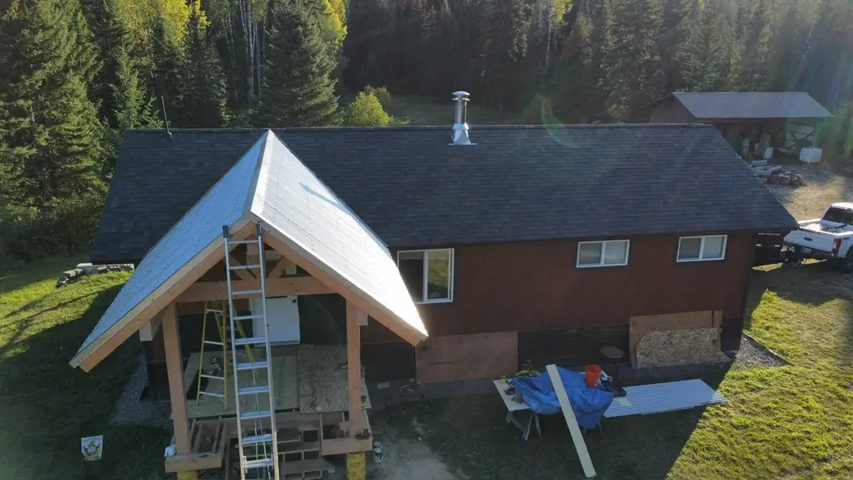 Drone aerial of a completed roof with mountains behind