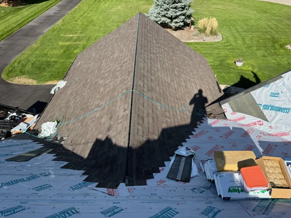 Sisu crew installing shingles on a steep pitch