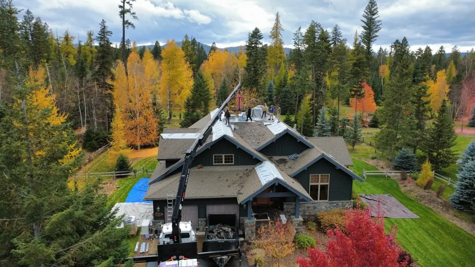 Home with newly installed architectural asphalt shingles in fall